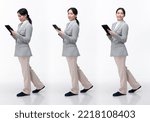 Small photo of Full Length 20s Asian Woman wear formal business blazer suit dress pant shoes. Black long straight hair female hold tablet work confident, walking forward turn left right, white background isolated