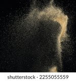 Small photo of Sand flying explosion, Golden sand wave explode. Abstract sands cloud fly. Yellow colored sand splash throwing in Air. black background Isolated high speed shutter, throwing freeze stop motion
