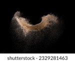 Small photo of Natural Sand flying explosion, particle dot grain wave explode. Abstract cloud fly. Brown colored sand splash throwing in Air. Black background Isolated