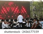 Small photo of Jakarta, Indonesia - March 11 2024: An orchestral music group is performing music at an event led by a conductor whose job is to regulate the tempo, harmonization and emotion of the songs being played