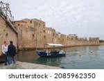 Small photo of Acre, Israel, December 04, 2021 : Well-preserved old fortress walls overlooking the Mediterranean Sea at the port area in Acre old city, in northern Israel