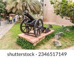 Small photo of Abu Dhabi, United Arab Emirates, March 19, 2023 : An old cannon stands in the courtyard of the Heritable village Abu Dhabi museum in Abu Dhabi city, United Arab Emirates