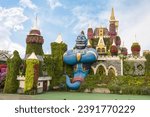 Small photo of Dubai, United Arab Emirates, March 21, 2023 : Giant figure of fairytale genie against backdrop of fairytale palace in botanical Dubai Miracle Garden with different floral fairy-tale themes, Dubai, UAE