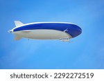 A blue and white airship with...