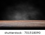 Old wood table with smoke in the dark background. 