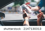 Small photo of Gas station worker swipe mockup credit card via payment terminal after giving a price quote to the customer sitting in the car.
