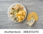 Cheese plate on a white table. Many kinds of cheese on a plate