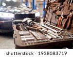 Dirty set of tools and wrenches close-up in box. Technical service station for car. Tool to repair the car or replace automotive spare parts, auto parts.