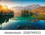 Small photo of Impressive summer sunrise on Eibsee lake with Zugspitze mountain range. Sunny outdoor scene in German Alps, Bavaria, Germany, Europe. Beauty of nature concept background