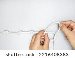Concept of solution problems. male hands unties a knot of rope. 