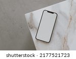 Aesthetic chic online store, online shopping, blog, social media branding composition. Mobile phone with blank copy space screen on marble side table. Neutral colors template