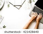 Workspace with laptop, girl's hands, notebook, sketchbook, white vintage tray, candlesticks on white background. Flat lay, top view office table desk. Freelancer working place