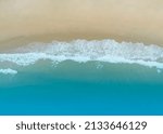 Amazing Sandy coastline with white turquiose sea waves. Beautiful Aerial view of white sand beach and water surface texture background
