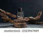 Top view of parfum on two wooden cutting boards stacked on top of each other on dark color background with free space