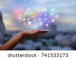 Mobile application concept.Man using touch screen smart phone on blurred urban city background