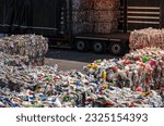Small photo of Collected and Sorted PET Bottles and Other Plastic Waste Going to Materials Recovery and Recycling Facility. Semi Truck Loading.