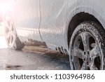 car wash self-service; Manual car wash. Washing luxury vehicle with white foamy detergent. Automobile  cleaning self service