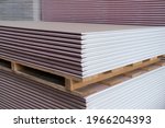 The stack of Plasterboard fire-resistant gypsum board cardboard surface Panel Type DF for indoor concrete walls prepared for construction 