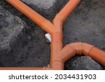 Prepared Drainage System from Plastic pipes made by plumber in the ground during the building of a modular house in Europe. Construction Engineering concept