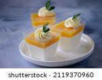 Orange  panna cotta in a portion cups, citrus fruits dessert, low calorie sweets, healthy sweets, mousse cake, recipe menu background