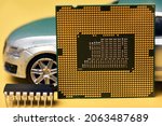 Small photo of CPU chip and semiconductors with car toy. Global car chip shortage. Micro-chip shortage creates dearth of new cars. Computer chip shortage stalls car industry production
