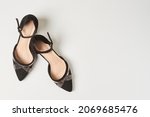 Pair of elegant women high heel shoes on white floor. View from above. Womens high heels and platform shoes. Stylish female high heels
