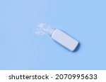 Small photo of Baby powder on blue background. Top view. Baby talcum powder container. Baby powder with bottle or container on blue