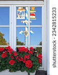 Small photo of Maypole in Haar reflected in the window of Gasthof zur Post, Munich County, Bavaria, Germany