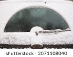 Small photo of Car wiper blade remove snow from car window. Snow flakes covered the car in a thick layer. Preparing for the trip in a winter, snowy day on the icy car. Safe winter driving. Selective focus
