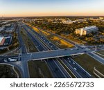 Small photo of golden hour sunrise iver toll roads ans bridges Transportation Highway aerial drone sunrise over busy road way in Austin , Texas , USA