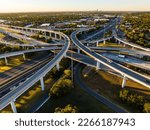 symetrical turnaround interchanges elevated Transportation Highway aerial drone sunrise over busy road way in Austin , Texas , USA