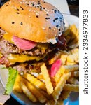 Small photo of Cafe Burger from danish restaurant i Blokhus. The burger is called “Manhood burger” 600g of beef, bacon and cheese sauce. The Happy pig Cafe