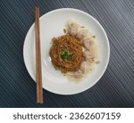 Small photo of stir fried dry soy sauce wanton noodle mee with pork chicken meat dumpling in plate on dark grey wood background asian snack dim sum halal food appetiser restaurant cuisine banquet menu for cafe