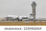 Small photo of Austin Texas- JAN 28, 2023 Austin-Bergstrom International Airport Elon Muck Gulfstream G650ER Landing Runway 18L in Rainy Conditions