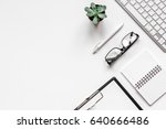 office flat lay with keyboard, glasses, notebook on white background top view mockup