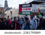 Small photo of Toronto Ontario Canada 10 28 2023 Woman holds a sign saying genocide is never justified at a Palestinian rally against the war in Gaza in Toronto Ontario Canada