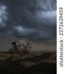 Small photo of Scary dilapidated abandoned house under a dark cloudy sky