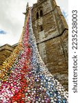 Small photo of The north tower of All Saints church in Middleton Cheney decorated with crochet flower and animals