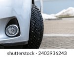 Small photo of Car winter tire with studs. Safe winter driving. Studded tires. Stud. Safety in Every Tread: Winter Tire Assurance for Road Security. Winter Road Guardian: Navigating Safely with Traction Assurance