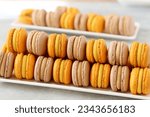 Small photo of Sun-kissed yellow macarons radiate with tropical allure, showcasing the finesse of French patisserie. Each piece, a harmonious blend of crisp exterior and luscious interior