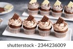 Small photo of Decadent chocolate cupcakes topped with luscious Oreo cookie pieces and rich chocolate chunks, presenting a harmonious blend of textures and flavors in every velvety bite
