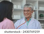 Small photo of A young Asian female patient is being examined by a medical professional, A dignified middle-aged male doctor is diagnosing a patient's body in order to plan a treatment.
