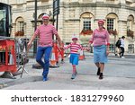 Small photo of Bath, UK - September 28, 2012: A family dress up as the character Wally from the British puzzle book Where's Wally by author and illustrator Martin Handford. Wally is know as Waldo in the US market.