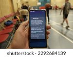 Small photo of An emergency alert message is seen on a smartphone as people play basketball on April 23, 2023 in London, UK. The UK government tested its alert system sending out alerts phones across the country.