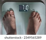 Small photo of The image showcases a moment of measuring weight on a scale. In today's society, where health and well-being take precedence, managing one's weight is a significant concern.
