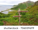 Wooden sign indicating directions to Nyksund and Sto in Vesteralen archipelago in Norway.
