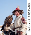 Small photo of Ulgii, Mongolia - September, 30, 2023: Northern Mongolia. Portrait of a male hunter with a hunting golden eagle. Eagle hunters are individuals who train and hunt with golden eagles in Mongolia.