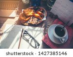 Diary for planning work schedules and appointment.Desktop laptop,calendar,clock,diary,book,Cup of Coffee with bread (breakfast) and glasses on wooden desk,Working space at home.Urban Lifestyle concept