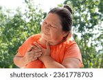 Small photo of mature woman 50-55 years old holds on to heart, sudden chest pain, close up female face with facial expression suffering, Ischemic heart disease, Arterial hypertension, Myocarditis or Arrhythmia