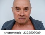 Small photo of close-up male face makes negative grimaces aggression, mature man, senior 60 years old with foolish threatening facial expression, concept mental human health, optimism in adulthood, midlife crisis